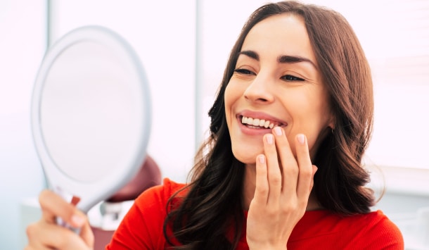 Patient looking at her new dental implant